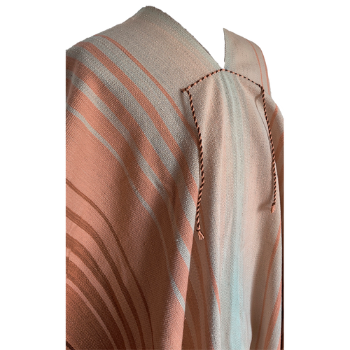 Close-up of Angostura Argollas poncho with beige, rose and brown natural tones