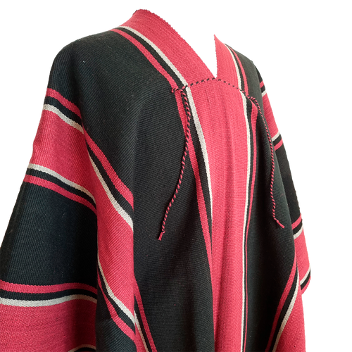 Close-up of Atuel Listado poncho with red, black and natural stripe details