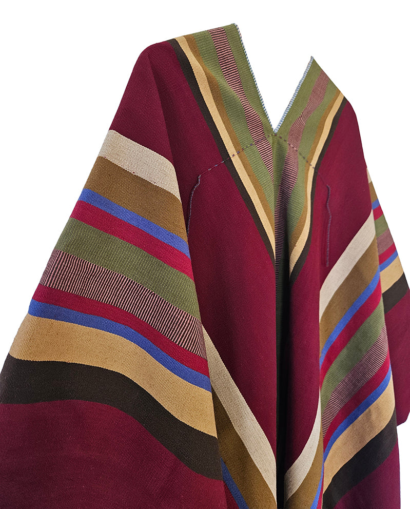 Close-up of Pichanal Listado poncho with natural sheep wool and colorful woven stripes
