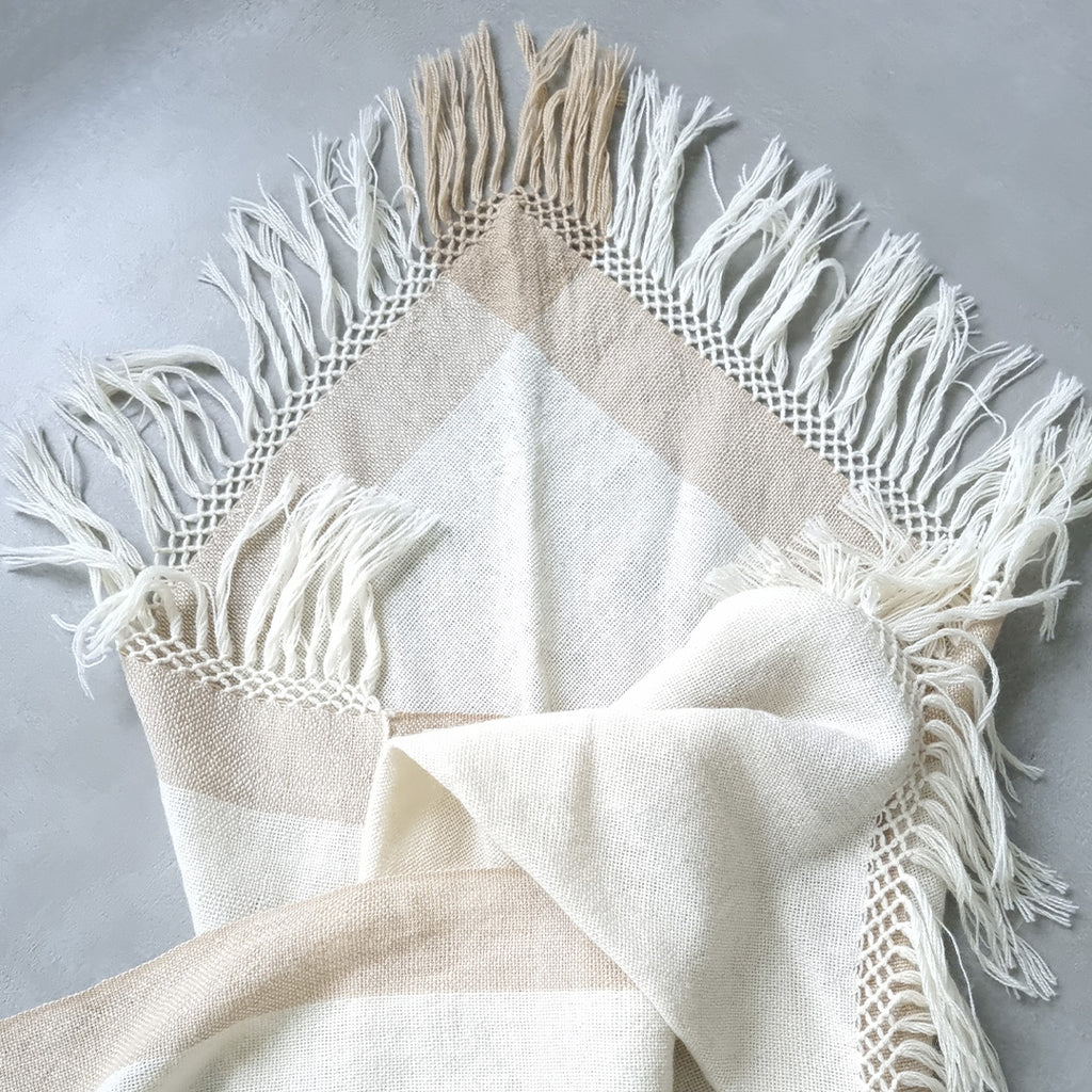 Cream sheep wool ruana with wide beige stripe and fringed edges