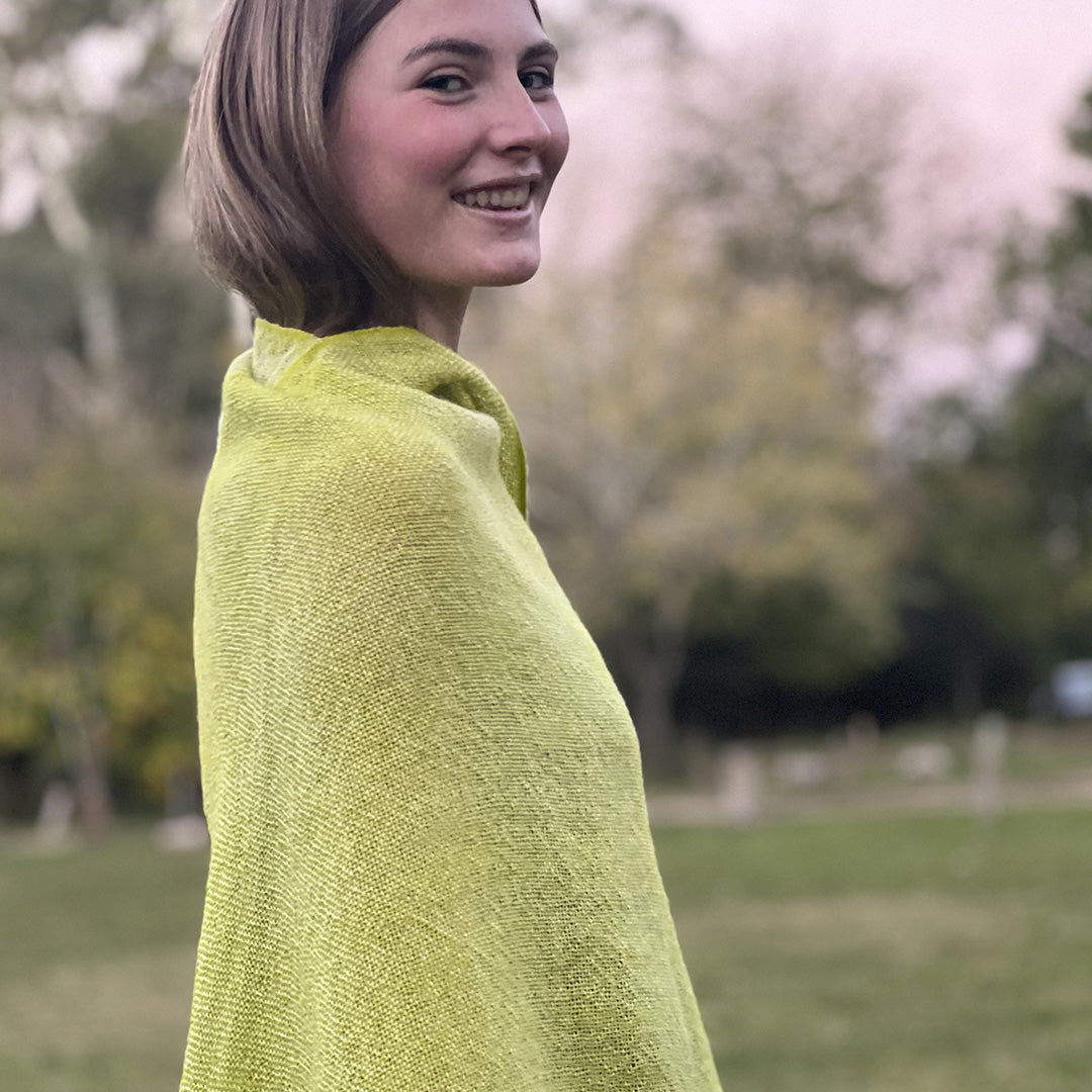 Pampa Neon ruana with colorful textile movement and fringed finish